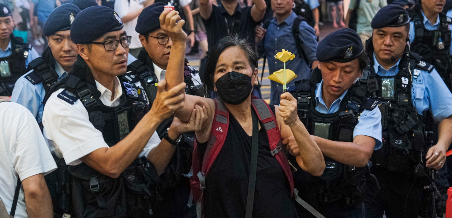 Chan Po-ying, an activist and leader of League of Social Democrats, is detained by police officers at Causeway Bay near Victoria Park